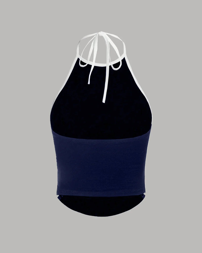 Back of a navy blue and white sporty halter neck racerback top with ruched sides, perfect for an athletic look
