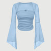 Square neck long sleeve top in light blue featuring sheer flare sleeves, a fitted ruched bodice, and a small decorative bow at the neckline