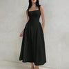 Front view of black square neck dress with sleeveless design, fitted bodice and flared midi length silhouette.