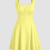 A-line mini dress in yellow featuring a square neck and straps, designed with a corset style for a flattering fit