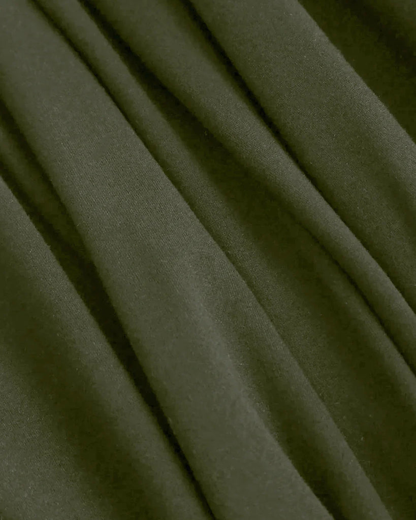 Closed view of a Green halter cowl neck jumpsuit made from soft, stretchy material with wide legs.