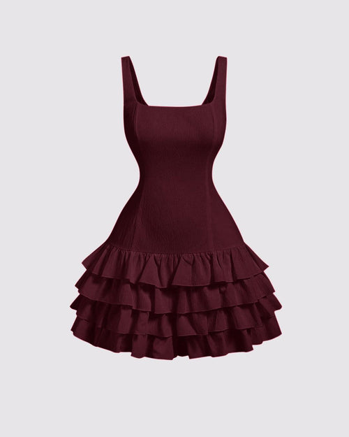 Cherry red mini dress featuring a square neckline, fitted bodice, and a voluminous tiered ruffle skirt