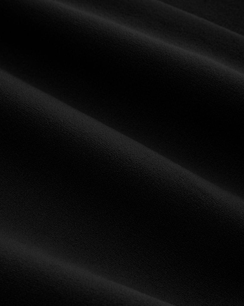 Close up of Black long sleeve top with a square neck and a tie scarf detail.