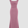 Front view of Pink square neck maxi dress with ruched bodice and shimmer fabric, featuring a fitted mermaid silhouette that flares at the hem