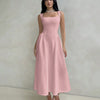 Model in a dusty pink sleeveless fit and flare midi dress featuring a square neckline.