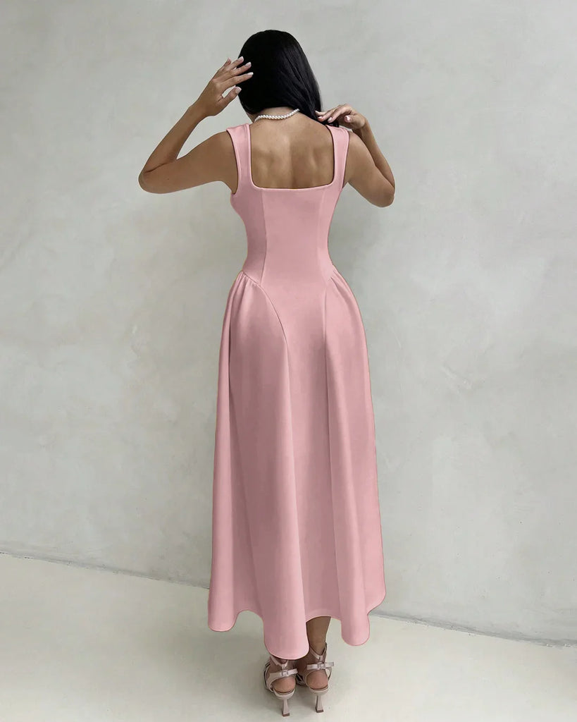 Back view of a Model in a dusty pink sleeveless fit and flare midi dress featuring a square neckline.