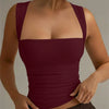 Women wearing Maroon square neck sleeveless tank top with slim fit and straight hem, featuring a smooth fitted silhouette