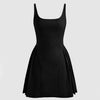 Black mini dress featuring a square neckline and pleated cami design