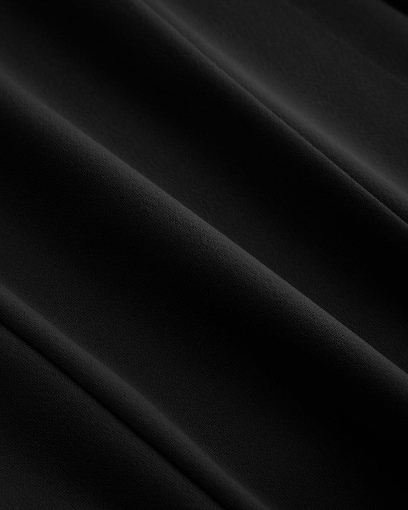 Black mini dress featuring a square neckline and pleated cami design close view