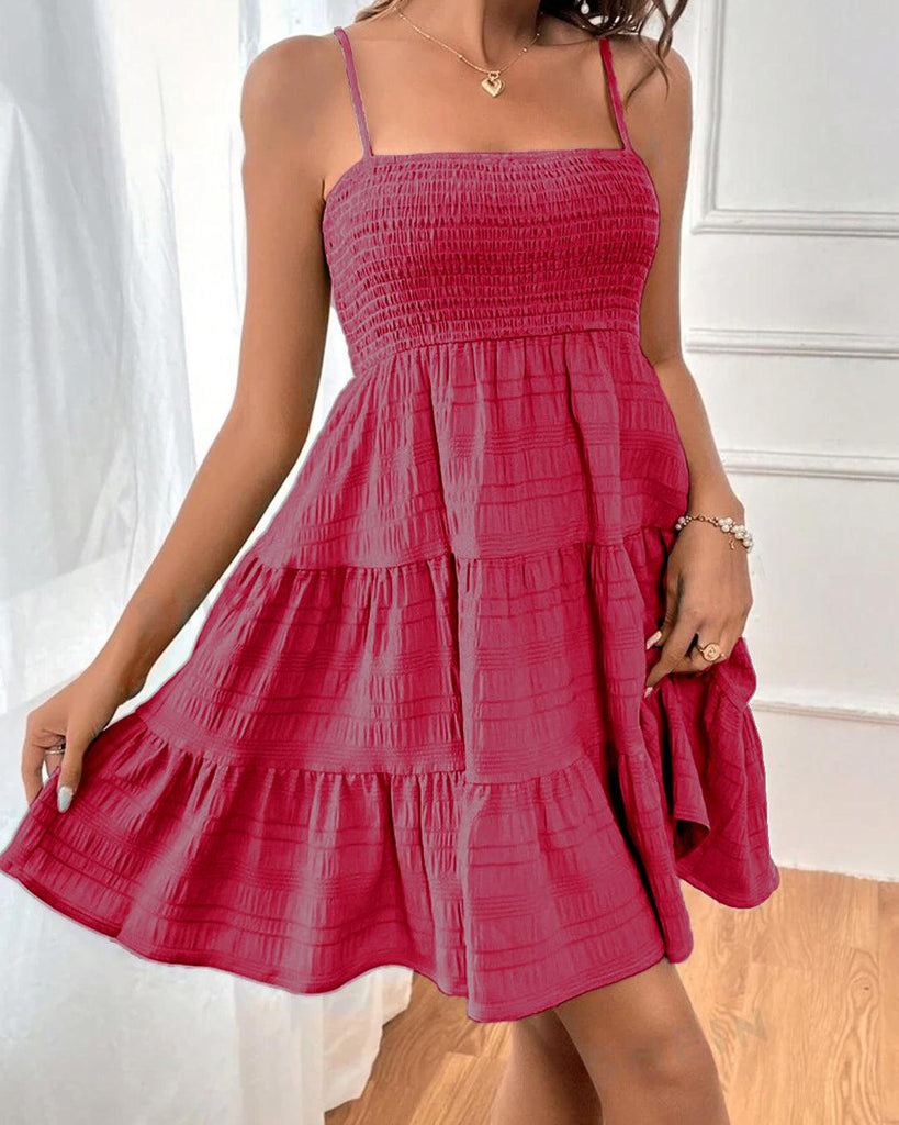 A pink beach dress featuring a square neckline and spaghetti straps for a breezy, effortless look.