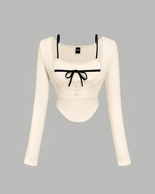 Front view of Off-white long sleeve sweater featuring black trimming along the edges.