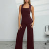 Model showcases a burgundy Square Neck Wide Leg Jumpsuit, featuring stylish wide legs and a flattering silhouette.