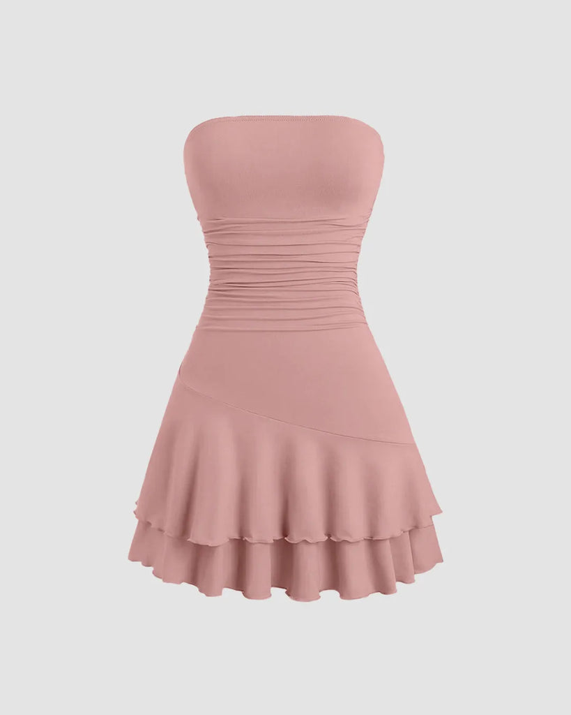 A rose-colored strapless mini dress featuring a fit-and-flare silhouette with layered hem detailing for a soft, sculpted look.