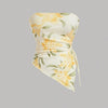 Front view of Yellow and white floral print top with asymmetrical design and ruched strapless style.