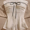Front view of white colour top strapless lace ribbon bow design with pleated fabric and fitted silhouette.