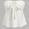 Front view of White polka dot top with strapless neckline, front tie detail and ruched bodice creating a flattering flared silhouette