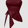 Front view of Red satin strapless sleeveless crop top with a slim fit design, ruched hem, and tie detail for a chic party look.