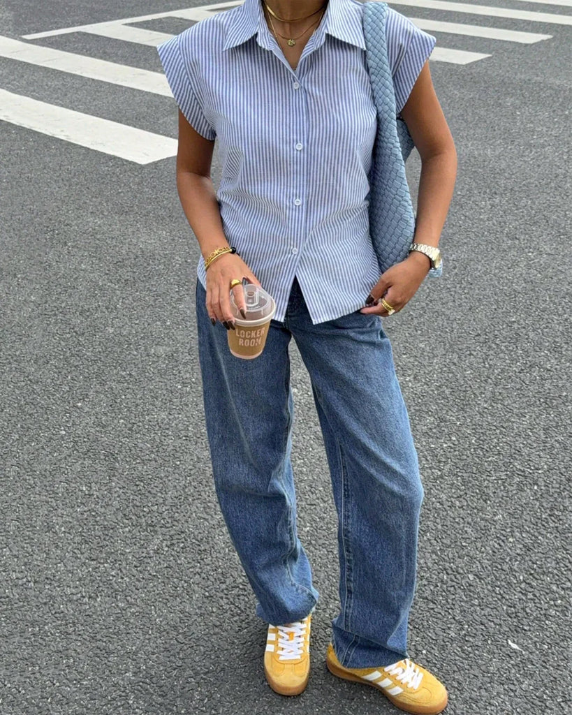a sleeveless blue and white striped button-down shirt