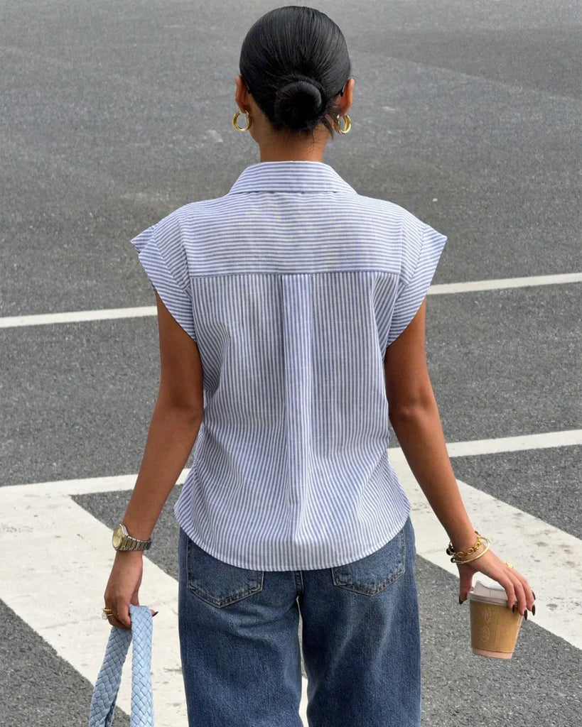 Back view of a sleeveless blue and white striped button-down shirt
