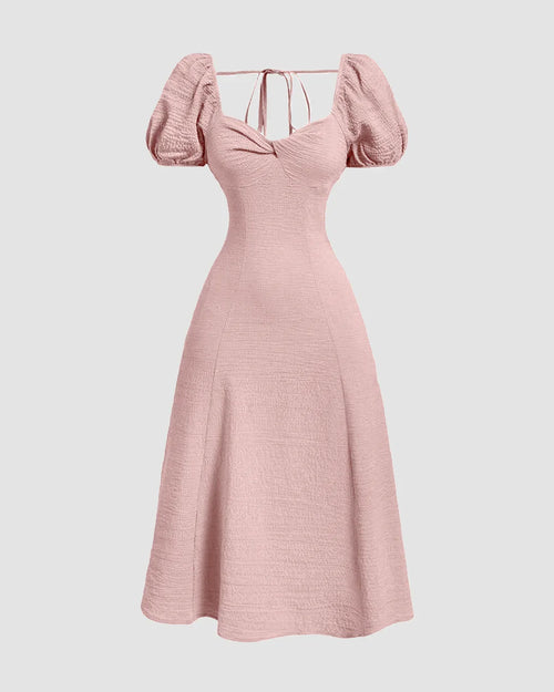 Front view of Powder pink cotton dress with puff sleeves and cinched waist, perfect for summer elegance.