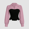 Front view of Pink and black top with contrast corset-style bodice, collared neckline and long puff sleeves for a bold layered look