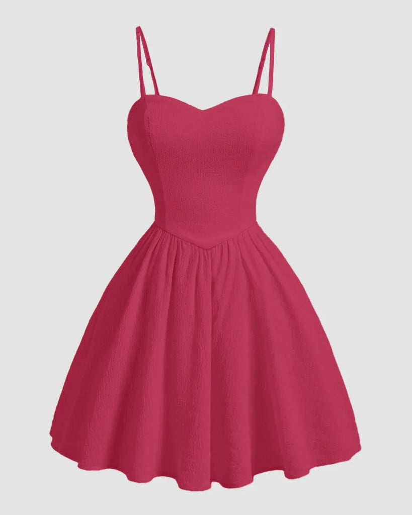 Hot pink sleeveless mini dress with a sweetheart neckline and a heart design on the front.