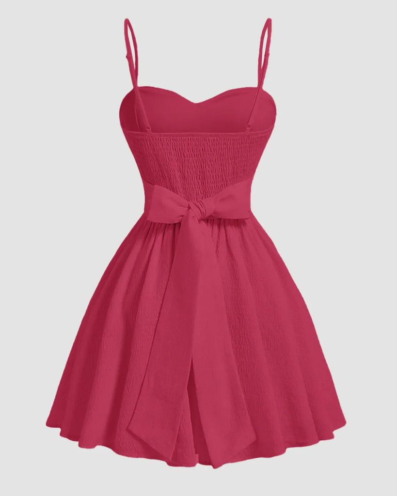 Back view of a Hot pink sleeveless mini dress with a sweetheart neckline and a heart design on the front.