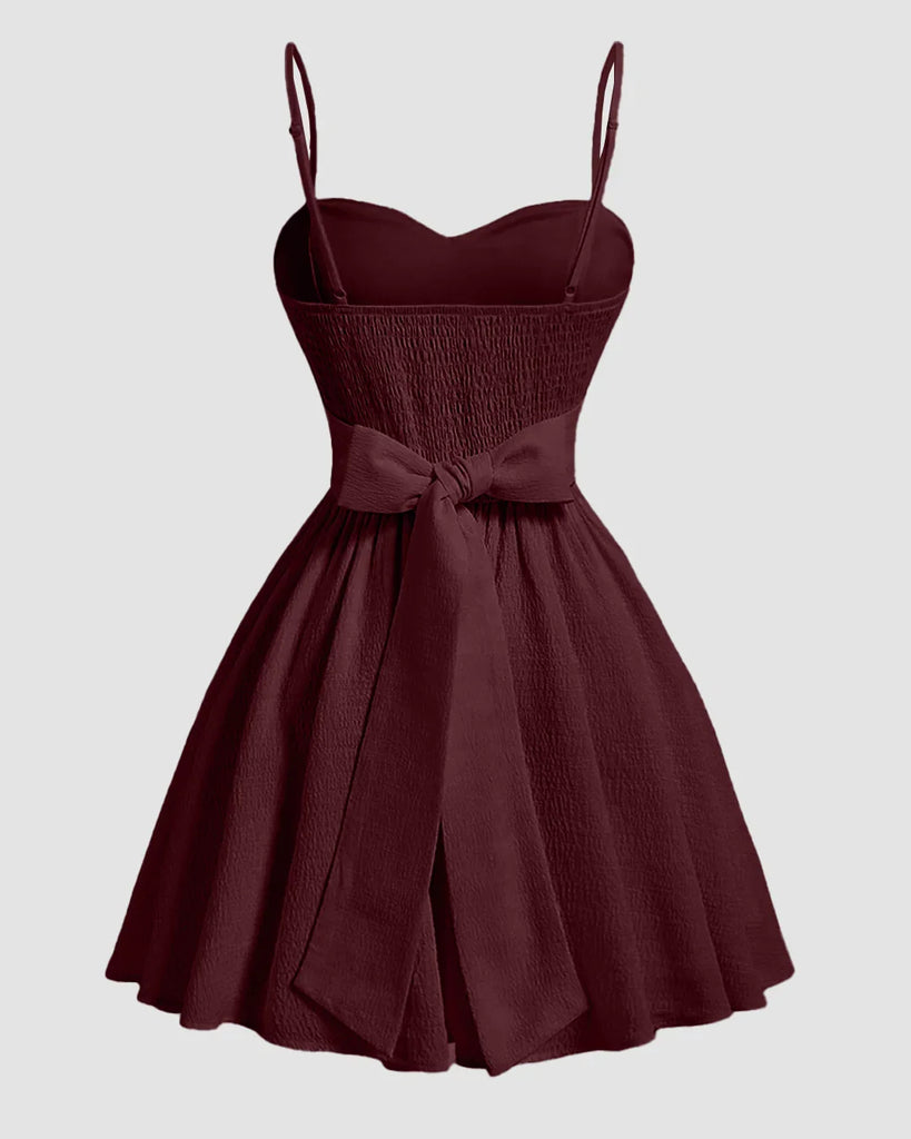 Back view of a Burgundy sweetheart neck fit and flare mini dress with spaghetti straps, showcasing a stylish and elegant design.