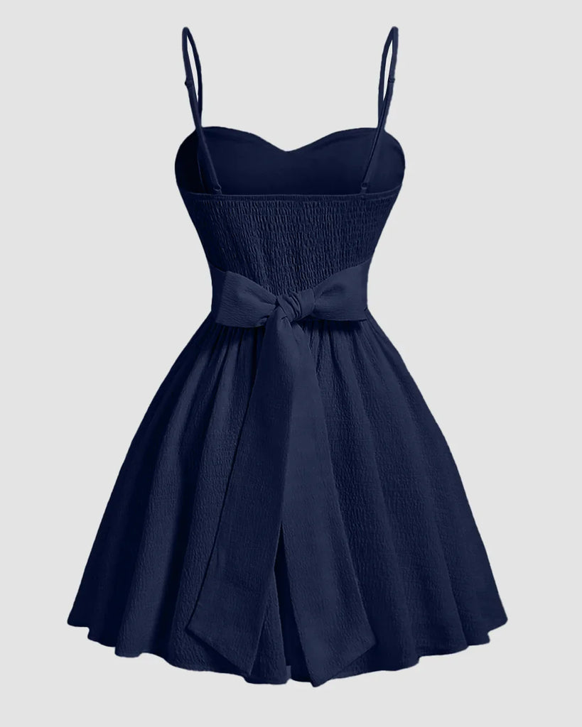 Back view of a Navy blue sweetheart neck fit and flare sleeveless mini dress with spaghetti straps.