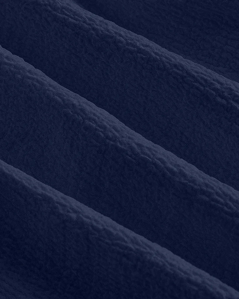 Closed view of a Navy blue sweetheart neck fit and flare sleeveless mini dress with spaghetti straps.