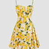 Front view of Yellow lemon print fit-and-flare mini dress with sweetheart neckline and lace-up back on a neutral background.
