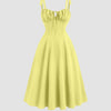 Yellow sweetheart neck midi dress with shoulder ties and a bow detail on the back.
