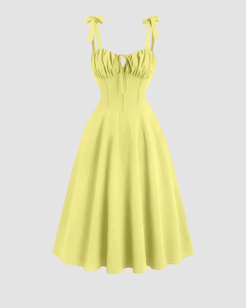 Yellow sweetheart neck midi dress with shoulder ties and a bow detail on the back.
