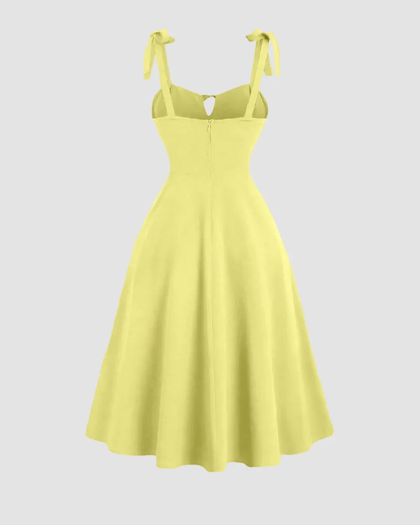 Back view of a Yellow sweetheart neck midi dress with shoulder ties and a bow detail on the back.