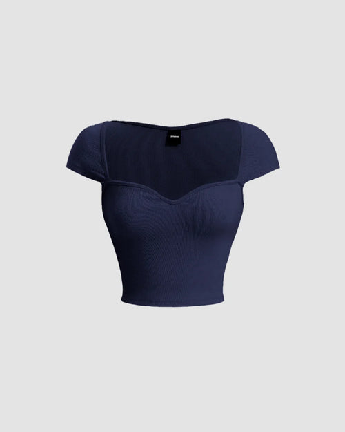 Front view of Sheer cap sleeve cropped top in navy blue, featuring a sweetheart neckline and crafted from a comfortable knit material.