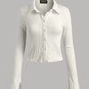 Front view of white cropped shirt with textured fabric, button front and bell sleeves for a fitted look.