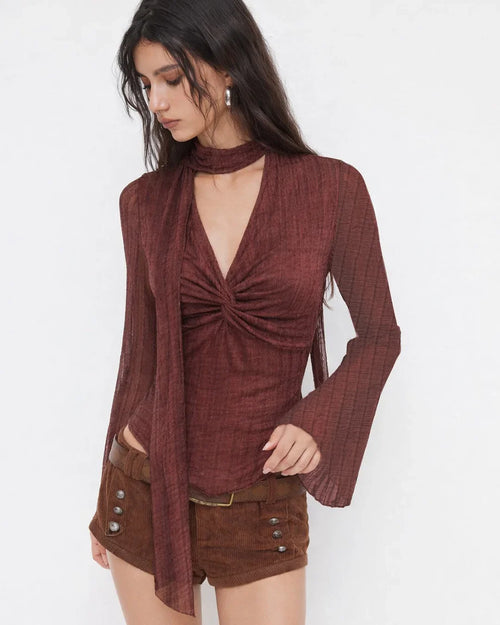 Women wearing Maroon textured V-neck top with twist front, flare sleeves and matching scarf detail, featuring a slim fit design