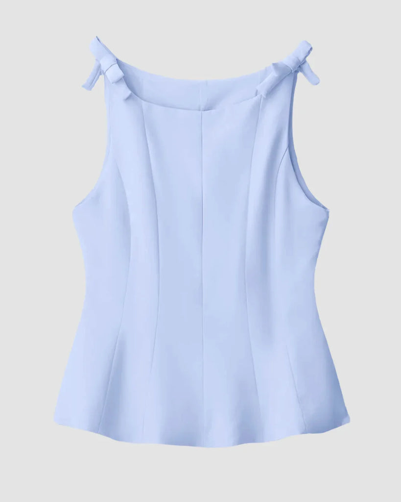 Powder blue fitted top featuring a stylish bow detail on the back.