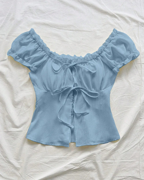 Front view of Off shoulder puff sleeve crop top with front tie detail, fitted waist shape, and soft lightweight fabric feel