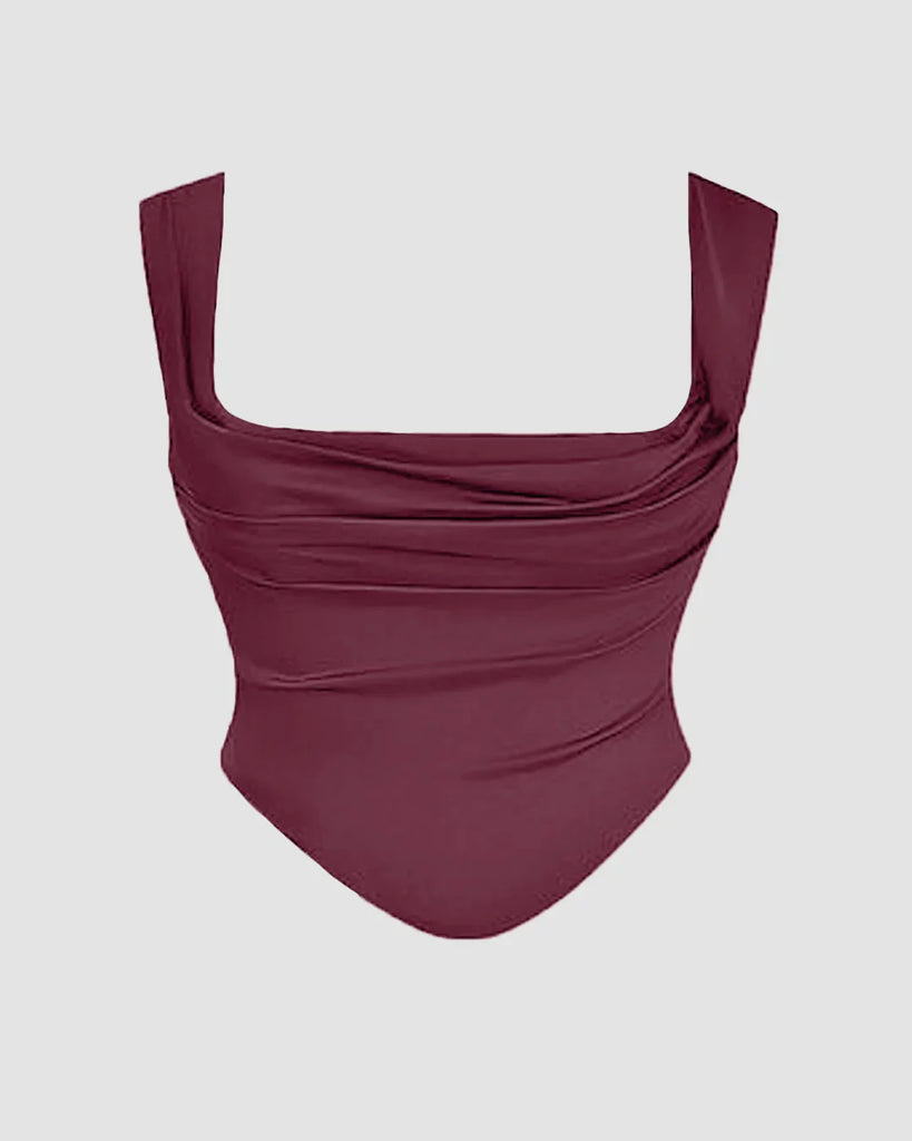 Close view of burgundy dress featuring a tied back corset top.