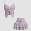 Twist front crop top and tiered mini skirt co-ord set in lilac, featuring a purple top and a pink skirt.