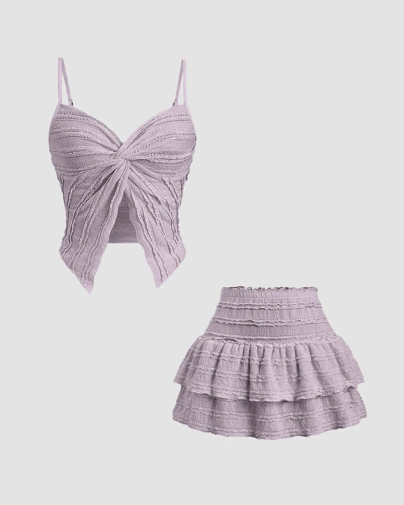 Twist front crop top and tiered mini skirt co-ord set in lilac, featuring a purple top and a pink skirt.