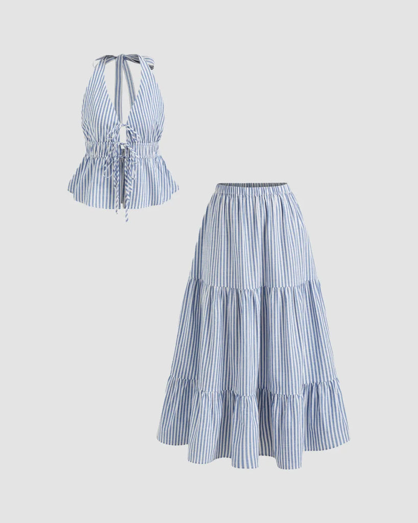 Model in a blue and white striped two-piece halter neck dress featuring a top and maxi skirt set.
