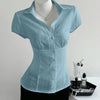 Front view of Sky blue shirt for women with V-neck collar and waist-cinched fit, textured fabric and short sleeves