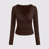 Chocolate Brown long-sleeved top with a V-neck, lace trim, and ruched design, showcasing elegant and stylish details
