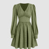  green mini dress with a textured fabric, V-neckline, corset-style waist, long puff sleeves, and a flared ruffle skirt