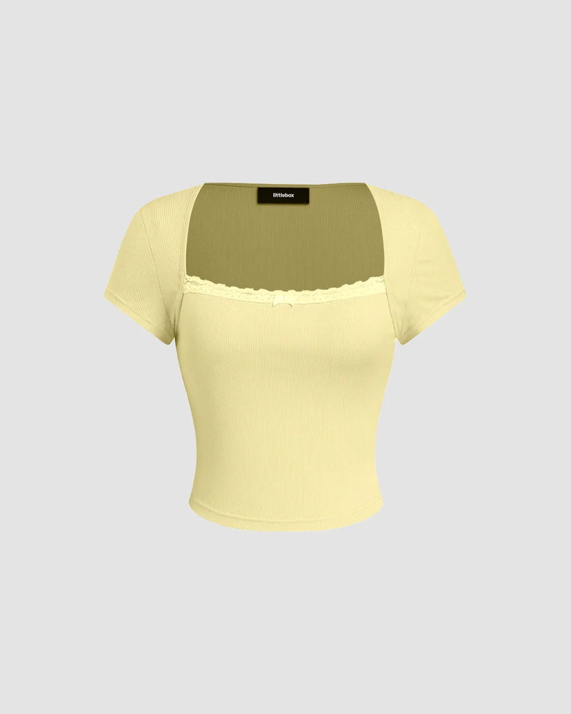 Yellow top with a vanilla hue, featuring a fitted design and sheer neckline detail for a stylish and elegant look