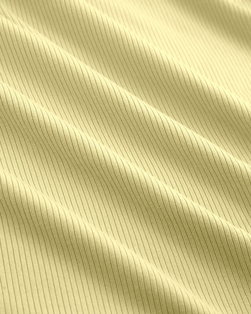 Fabric of Yellow top with a vanilla hue, featuring a fitted design and sheer neckline detail for a stylish and elegant look