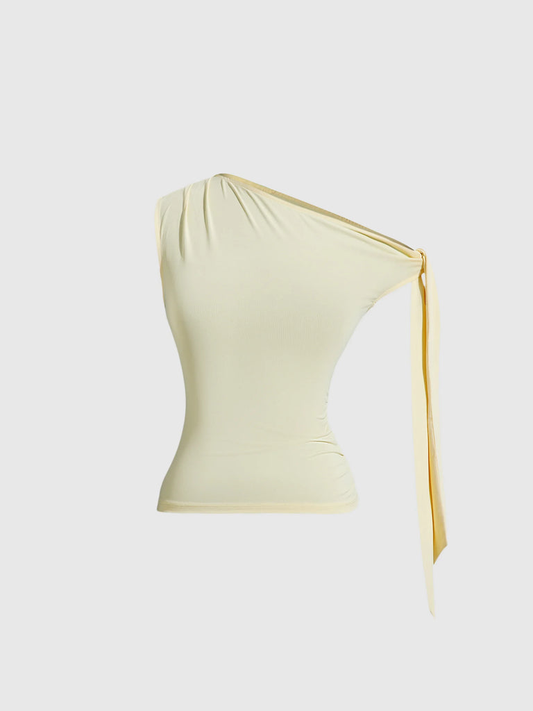 A vanilla one-shoulder top featuring an asymmetric design and a yellow ribbon tied at the side.