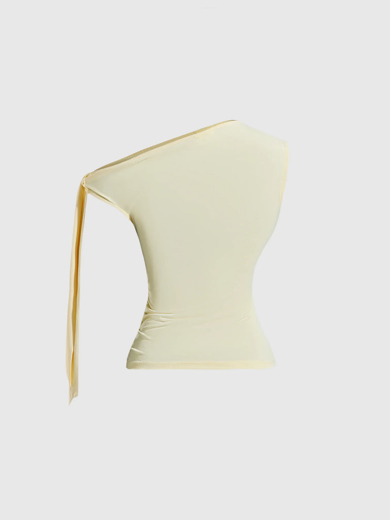 Back view of a vanilla one-shoulder top featuring an asymmetric design and a yellow ribbon tied at the side.
